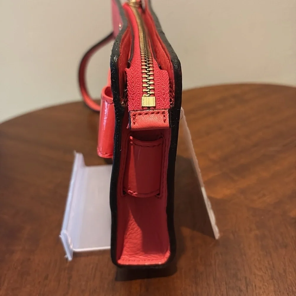 Kate Spade wristlet  pebble leather/patent bow on front  orangeish red gold NWOT